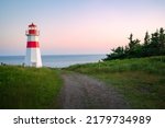 The beautiful Musquash head lighthouse at dusk, that overlook the coast over bay of fundy, St-John, New Brunswick, Canada