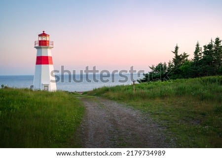 The beautiful Musquash head lighthouse at dusk, that overlook the coast over bay of fundy, St-John, New Brunswick, Canada