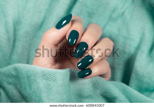 Beautiful\
nail polish in hand, green nail art\
manicure