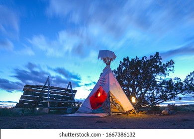 Beautiful native american indian teepee or tipi at sunset in the usa southwest. Seen while adventure traveling through the arizona or utah desert. Amazing vacation seen at night with light glowing. - Powered by Shutterstock