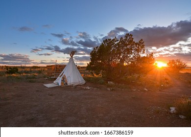 Beautiful native american indian teepee or tipi at sunset in the usa southwest. Seen while adventure traveling through the arizona or utah desert. Amazing vacation seen at night with light glowing. - Powered by Shutterstock