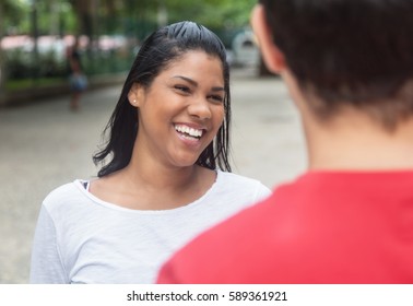 Beautiful Native Latin Woman Talking With Caucasian Friend Outdoor In The City