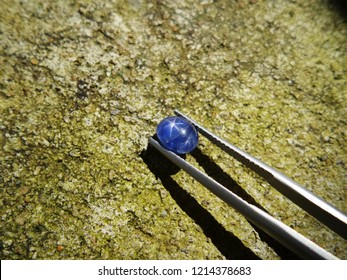 Beautiful natural ceylon blue star sapphire with old cement wall,gemstone background - Shutterstock ID 1214378683