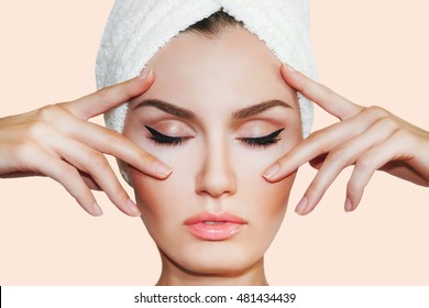 Beautiful natural girl woman after cosmetic procedures ,face-lift , facial massage , visit a beautician , massage lines. Beautiful woman with a towel on his head. 