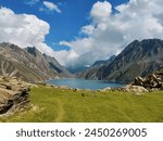 Beautiful and natural lake between hills in a Kashmir valley. Most peaceful View of nature in Mountain valley. Cloud in mountains with a beautiful lake