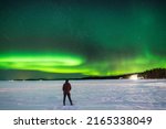 The beautiful natural phenomenon of the aurora borealis, or northern lights, over the frozen sea at Rovaniemi Finland.