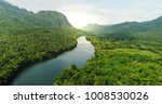 Beautiful natural scenery of river in southeast Asia tropical green forest  with mountains in background, aerial view drone shot