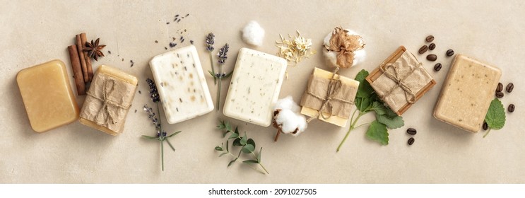 Beautiful Natural soap bars and ingredients on beige background, top view. Handmade organic soap concept, banner