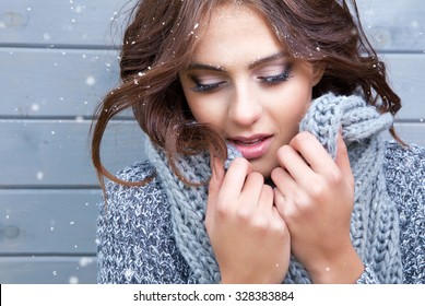 Beautiful Natural Young  Brunette Woman With Eyes Closed, Wearing Knitted Scarf, Covered With Snow Flakes. Snowing Winter Beauty Concept.