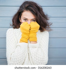 Beautiful Natural Young Smiling Brunette Woman Wearing Knitted Sweater And Gloves. Fall And Winter Fashion Concept.