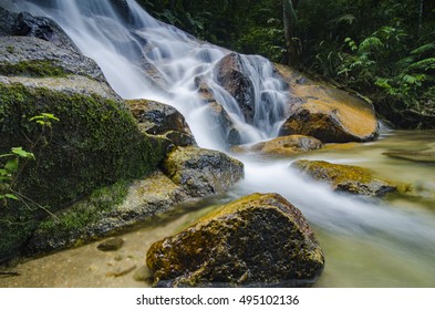 beautiful in nature, amazing cascading tropical waterfall. wet and mossy rock, surrounded by green rain forest - Shutterstock ID 495102136