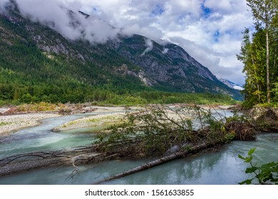 A Beautiful Nature Scene Of The Bella Coola River In BC, Canada Under The Bright Cloudy Sky