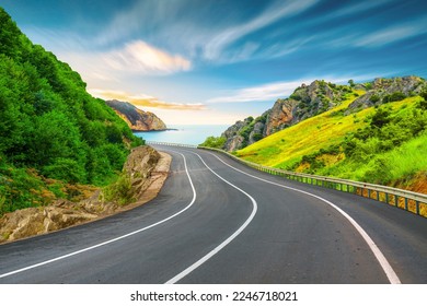 Beautiful nature scenery to travel on the colorful road landscape among the mountains by the sea. Traveling in the beach highway landscape during summer vacation. Turkey journey in green nature road.