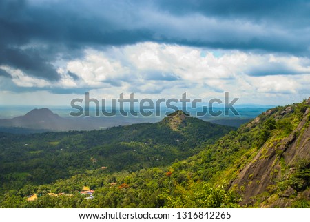 Beautiful Nature Scenery of Wayanad Edakkal Cave, blue cloudy sky with green mountains Kerala god's own country