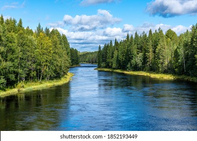 Beautiful Nature View Of The River Ore In Sweden, Flowing Through A Lush Green Forest In Sunlight