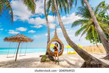 Beautiful nature view scenic landscape tropical palm beach with traveler woman on straw nests, Attraction famous place tourist travel Thailand summer holiday vacation trip, Tourism destination Asia