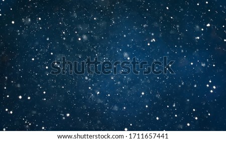 Beautiful Navy Blue Night Background with falling snow. Winter Christmas Holiday Texture. Background With Copy Space for design greetings cards or promotion flyers to Christmas and New year.