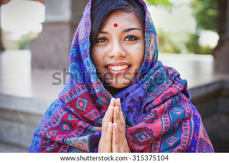 beautiful nepalese woman saying and performing namaste gesture
