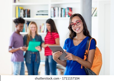 Beautiful Nerdy Female Student With Tablet Computer With Group Of Multi Ethnic College Students At Classroom Of University