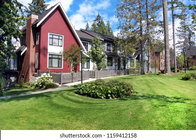Beautiful new contempory suburban attached townhomes with colorful summer gardens in a Canadian neighborhood.