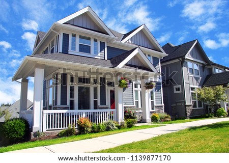Beautiful new contempory suburban houses with colorful summer gardens in a Canadian neighborhood.