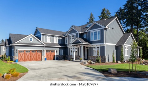 Beautiful New Luxury Home Exterior. Traditional Home In Suburban Neighborhood With Three Car Garage, Two Stories, And Columns In Entry.