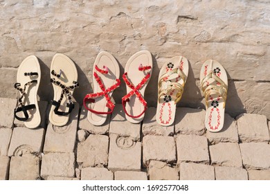 Beautiful New Women's Shoes Lined Up In A Row Against A Wall.