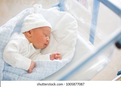 Beautiful newborn baby boy, laying in crib in prenatal hospital - Shutterstock ID 1005877087