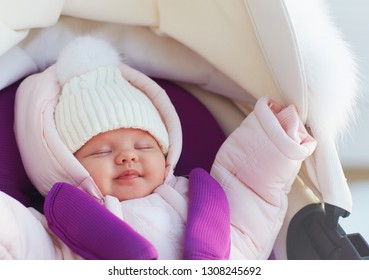 Beautiful Newborn Baby Girl Sleeping Peacefully In Pram During A Winter Walk