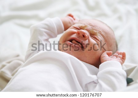 Beautiful newborn baby lying in his bed