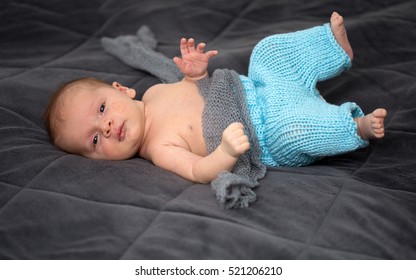 Beautiful newborn baby on dark blanket 