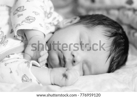 Similar – Newborn lying on the bed with her mother