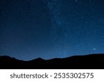 Beautiful night landscape, Bright Milky Way galaxy over the mountains, starry sky. 