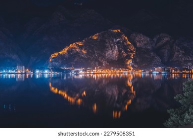Beautiful night landscape. City in Montenegro Kotor with an old fortress reflected in the bay. Adriatic Sea travel  - Powered by Shutterstock