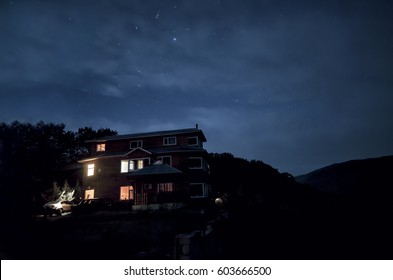 Beautiful Night Scene Of A Lone House With Lights On Windows. Azerbaijan. Masalli. Vilesh Lake Talish Mountains