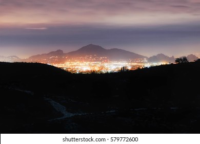 Beautiful Night Scenery With Cloudy Sky And City Lights. Camel Back Mountain, Phoenix, Arizona At The Distance. 