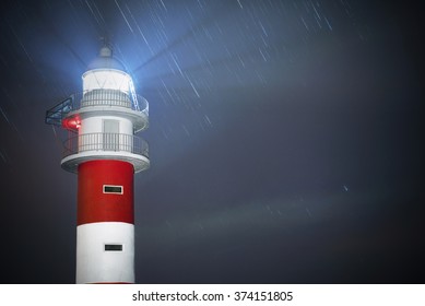 Beautiful Night Shot Of A Lighthouse With Star Trails In The Background In Punta De Teno, Tenerife, Canary Island,  Spain. 