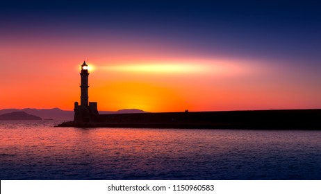 A beautiful night sky behind a shining lighthouse. Chania, Crete, Greece