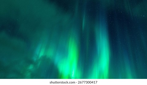 A beautiful night sky filled with an array of vibrant green northern lights or aurora borealis
