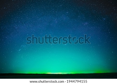 Beautiful Night Sky Glowing Stars Background Backdrop With Colorful Sky Gradient. Colourful Night Starry Sky In Blue Aquamarine Green Colors. Dark Ground. Copy Space