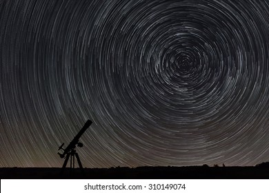 Beautiful night sky, Star trails over filed and astronomical telescope - Shutterstock ID 310149074