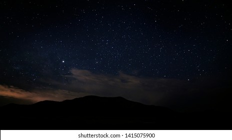 Beautiful Night Sky In The Utah Desert On A Summer Night With A Mountain In The Background.