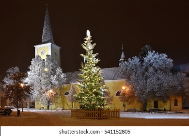 Beautiful Night Winter Photo Christmas Tree With Church And Snow.