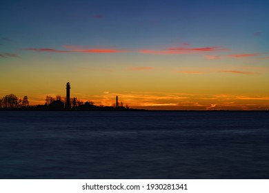 Beautiful nightly seascape with lighthouse and moody sky at the sunset.