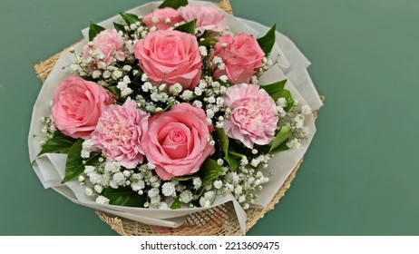 Beautiful Noblesse Roses And Pink Carnations In A Bouquet With Sage Green Wall Background.