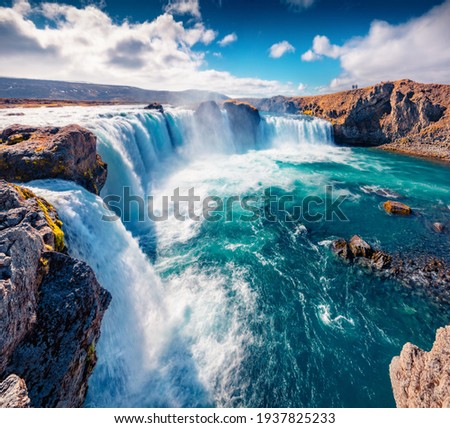 Beautiful Nordic scenery. Gorgeous summer scene of Skjalfandafljot river, Iceland, Europe. Exciting morning view of Godafoss, spectacular waterfall plunging over a curved, 12m-high precipice.