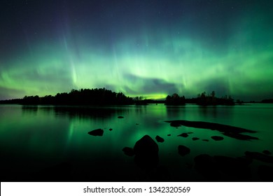 Beautiful Northern Lights Aurora Borealis Over Lake In Finland