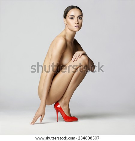 Beautiful Nude Lady With Perfect Body Sits In Red Shoes Conceptual Fashion Art Photo Beautiful Nude Lady With Perfect Body Sits In Red Shoes Conceptual Fashion Art Photo