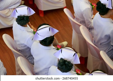 beautiful nurse in white coat and hat with single black stripe. - Shutterstock ID 268740455