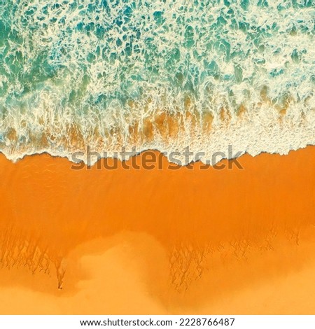 Beautiful ocean beach with yellow sand, aerial view.  Drone view of blue waves and sandy beach. Top view - Beautiful Ericeira beach is famous tourist destination.  Atlantic Ocean, Portugal. 
